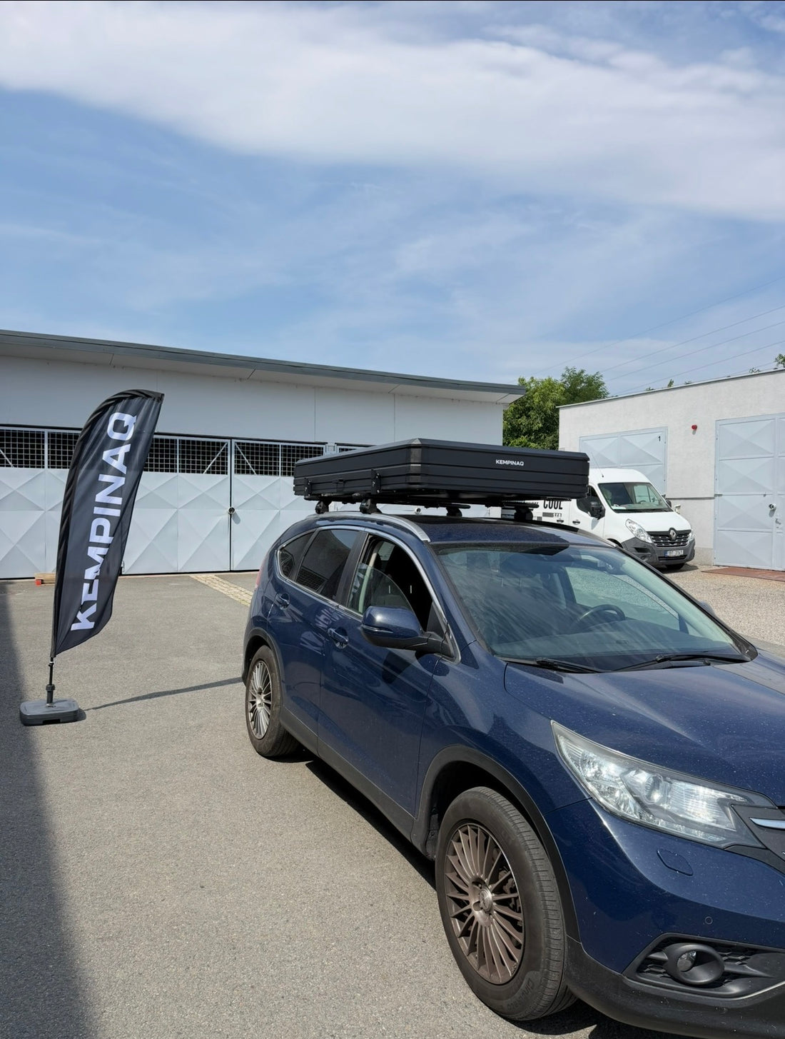 Auto s autostanem KEMPINAQ před showroomem